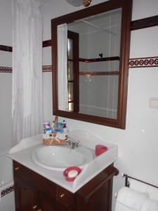 a bathroom with a sink and a mirror at Casa rural Villa Manuela in Cazalla de la Sierra