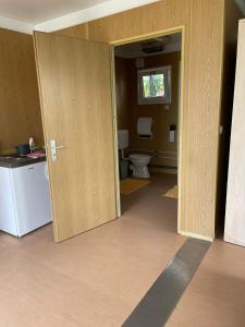 an open door to a bathroom with a toilet at LakePark Apartman in Bekecs +14 photos