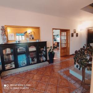 a living room with a mirror and a tiled floor at Casa Além Rio - quartos para 6 hóspedes em Santo Tirso in Santo Tirso