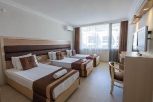 Postel nebo postele na pokoji v ubytování Hotel Caprea