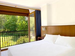Posteľ alebo postele v izbe v ubytovaní Hotel EntreRobles