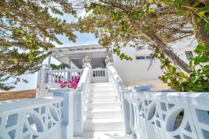 a staircase leading up to a white house with flowers at Las Nieves Suites in Teguise