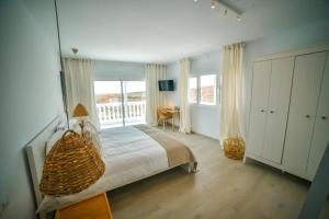 a bedroom with a bed with a large window at Las Nieves Suites in Teguise