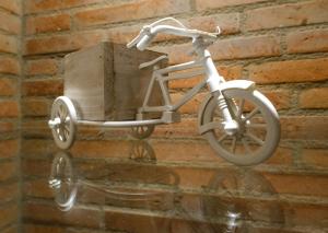 a white bike with a wooden box on the wall at BB Residence Sololaki in Tbilisi City