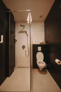 a bathroom with a toilet and a shower stall at ATOS Centar in Čelinac