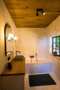 a large bathroom with a tub and a sink at The cabin Morris in Holsbeek