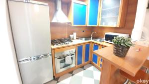 a small kitchen with a stove and a sink at House of Music - Bari Centro in Bari