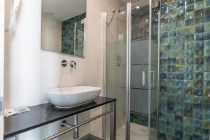 a bathroom with a sink and a glass shower at Hotel President in Lido di Jesolo