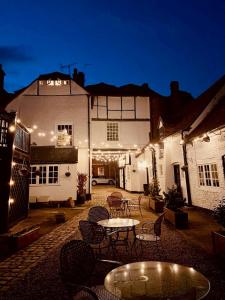 a patio with tables and chairs in front of a building at George & Dragon Hotel in Buckinghamshire