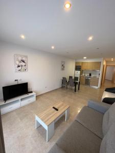 a living room with a couch and a table at Apartamentos Flamingo Hills in Benitachell