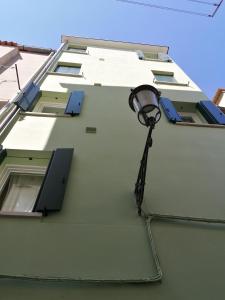 a street light on the side of a building at VERDEPOESIA in Chioggia