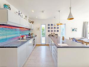 a kitchen with white cabinets and a counter top at Innisfree, Middleton on Sea in Middleton-on-Sea