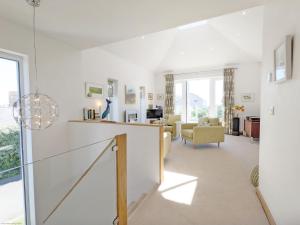 a living room with white walls and a large window at Innisfree, Middleton on Sea in Middleton-on-Sea