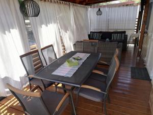 a dining table and chairs in a screened in porch at Mobile home Happy Summer in Biograd na Moru