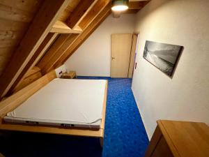 a small room with a bed in a attic at Familie Ising in Unterwörnitz