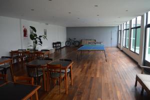 a room with tables and chairs and a table tennis court at Hotel Castellon in Mar del Plata