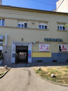 a building with a tunnel in front of it at Old Town apartments in Novi Sad