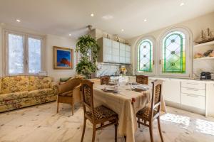 a kitchen and living room with a table and chairs at Piave Suites by Mmega in Forte dei Marmi