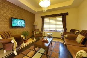 a living room with couches and chairs and a table at Lalehan Hotel Special Class in Amasya