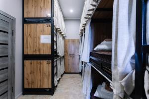 a room with bunk beds and wooden walls at DOMA HOSTEL in Almaty