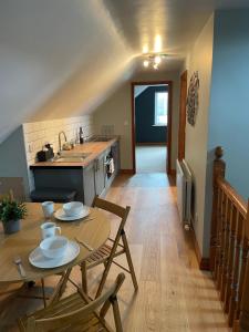 a kitchen with a table and chairs and a kitchen with a sink at Fabulous 2 Bed Apartment in Penrith +9 photos