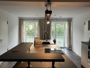 a living room with a large wooden table in the middle at Ferienwohnung Treibholz in Binz