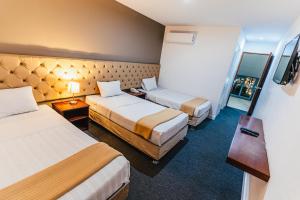Postel nebo postele na pokoji v ubytování Hotel Hacienda Lima Norte