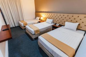 Postel nebo postele na pokoji v ubytování Hotel Hacienda Lima Norte
