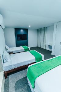Postel nebo postele na pokoji v ubytování Hotel Hacienda Lima Norte