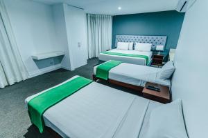 Postel nebo postele na pokoji v ubytování Hotel Hacienda Lima Norte