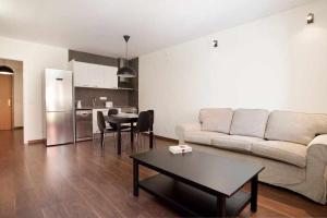 een woonkamer met een bank en een tafel bij Apart céntrico con terraza en Gracia in Barcelona