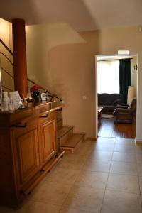 a living room with a staircase and a couch at Pensiunea Clasic Hunedoara in Peştişu Mare