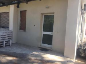a front door of a house with a car parked outside at Residences La Rustica & Elite in Eraclea Mare