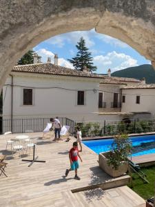 a group of people playing by a swimming pool at Dimora dell'Arte-CantinArte in Navelli