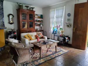 Pousada Vila Brasil في بتروبوليس: غرفة معيشة مع أريكة وطاولة
