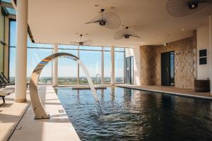 a pool with a fountain in the middle of a building at Van der Valk Hotel Schiedam in Schiedam