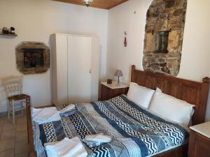 A bed or beds in a room at Magnolia Traditional Stone House in Vamvakou