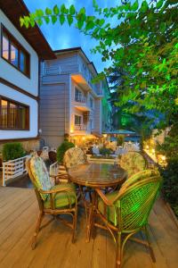 a patio with a table and chairs on a deck at Lalehan Hotel Special Class in Amasya