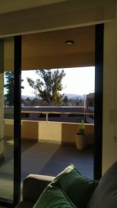 a living room with a view of a balcony at DPTO EN VILLA ALLENDE A ESTRENAR !! in Villa Allende