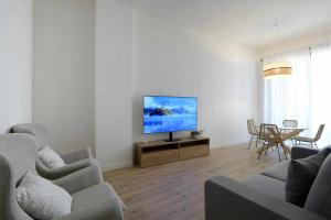 a living room with a flat screen tv on a table at Mike House Alójate en el corazón de Zaragoza in Zaragoza