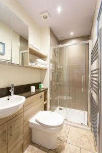 a bathroom with a shower and a toilet and a sink at Queens Head Hotel in Berwick-Upon-Tweed