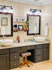 a bathroom with two sinks and two mirrors at Barren Breeze Bed and Breakfast in Lucas