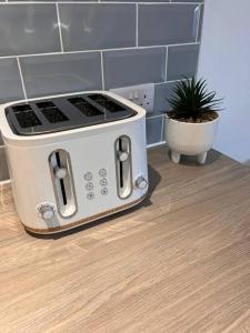 a toaster oven sitting on top of a kitchen counter at Stay at The Penn! 5 Bedroomed home in Treharris in Treharris