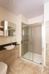 a bathroom with a shower and a toilet and a sink at Queens Head Hotel in Berwick-Upon-Tweed