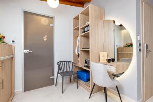 a small room with a desk and a chair at Metropolitan Pearl Boutique Hotel in Chania