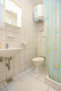a bathroom with a toilet and a sink at Apartments by the sea Poljica, Trogir - 10353 in Marina