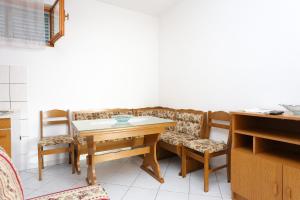 a dining room with a table and two chairs at Apartments by the sea Poljica, Trogir - 10353 in Marina