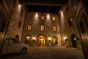 a car parked in front of a large building at Castello La Leccia in Castellina in Chianti