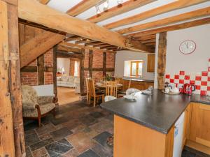 a kitchen and living room with wooden beams at Munderfield Mill in Bromyard +34 photos
