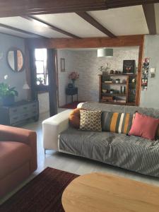 a living room with a couch and a table at Au Relais de l'Histoire Gîte classé 4 étoiles in Oberbronn